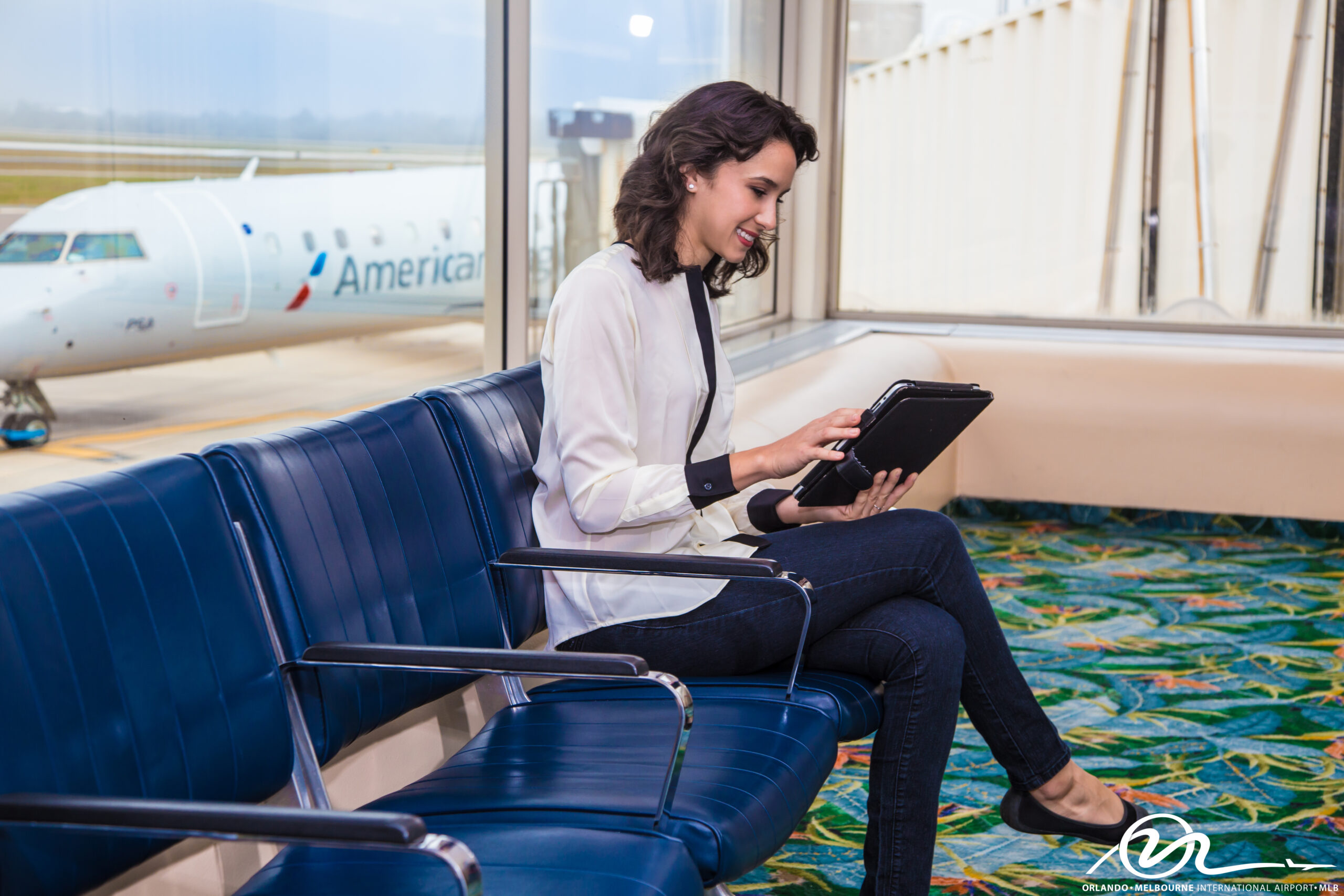 A woman using the complimentary WiFi at the Orlando Melbourne International Airport