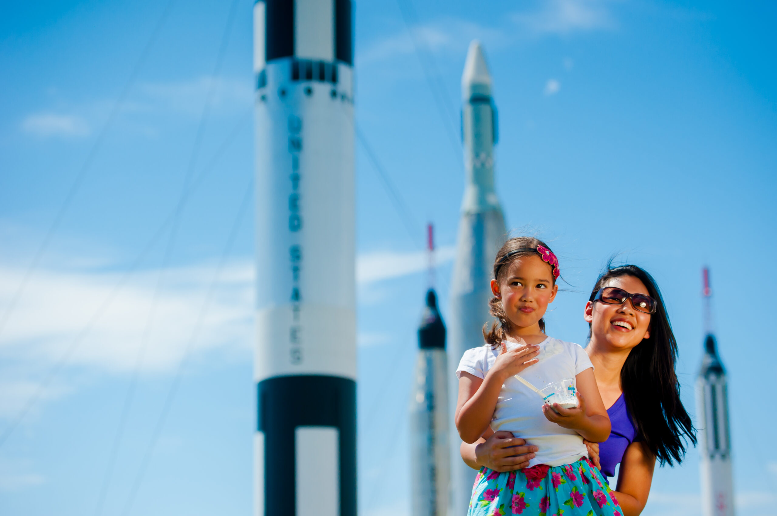 A mother and daughter marvel at the rockets on display at the Rocket Garden at the Kennedy Space Center