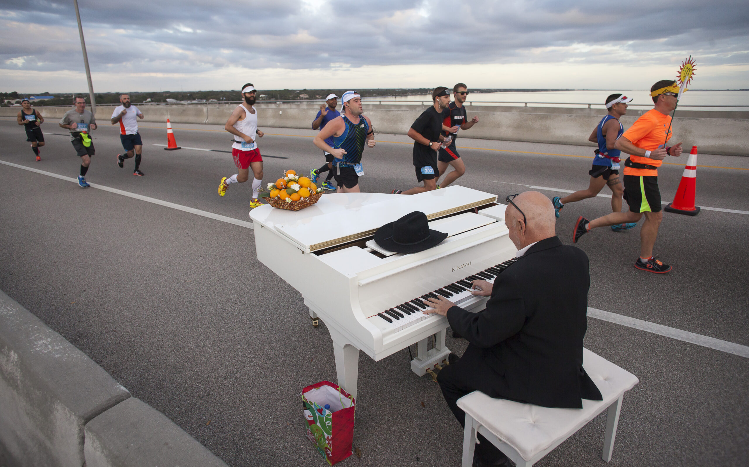 A piano player playing songs for runners in the Publix Florida Marathon in Melbourne, FL