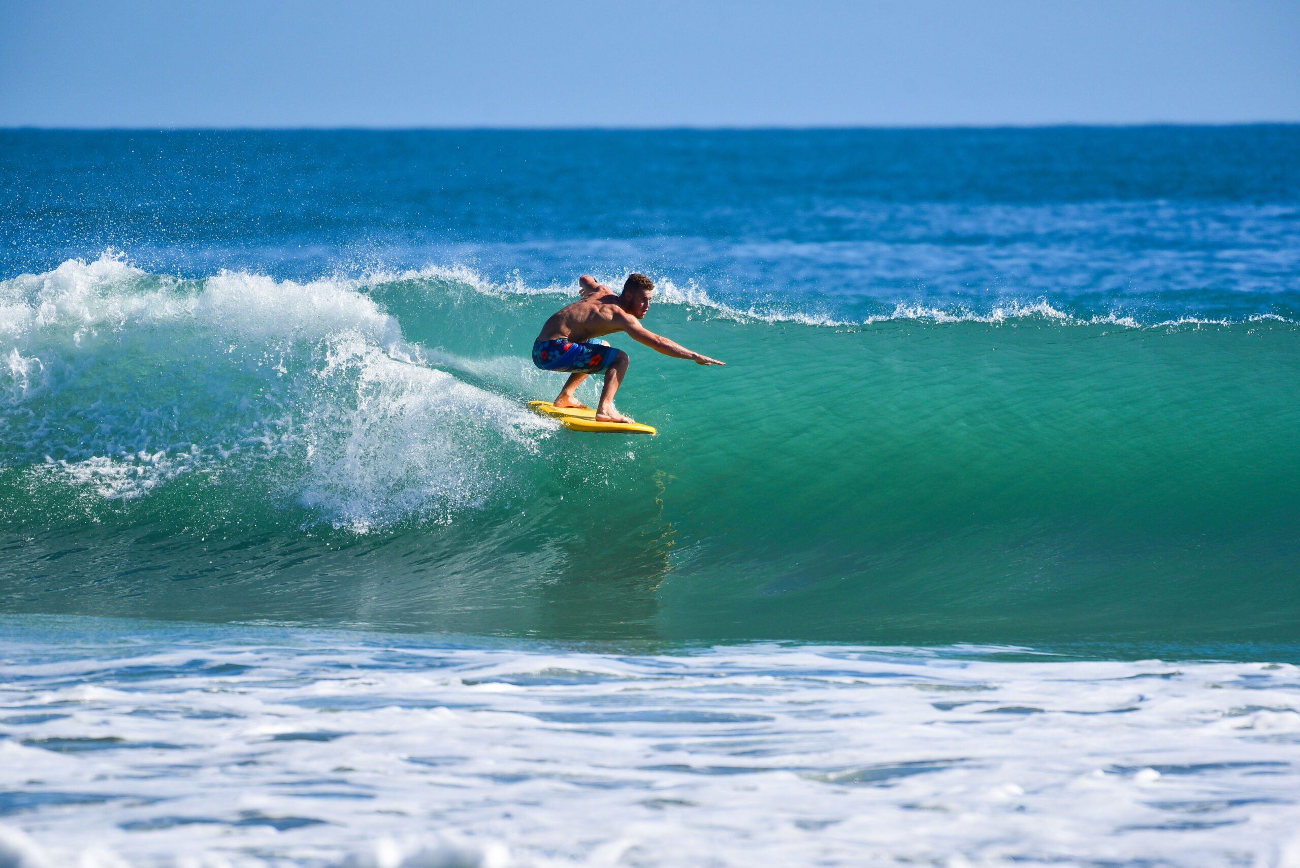 A surfer riding a wave in Melbourne Beach, FL