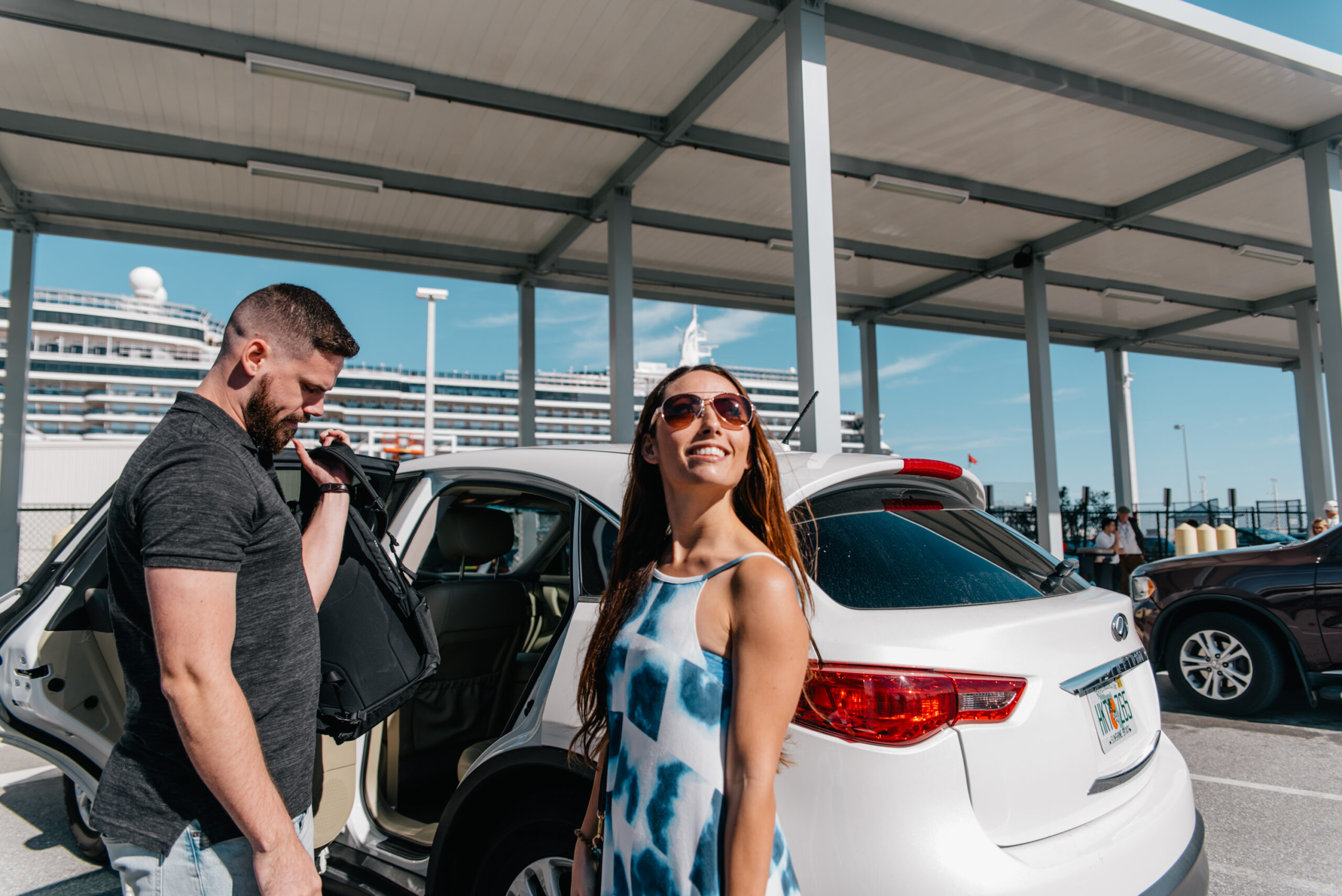 A couple unpacks the car at Port Canaveral for their cruise vacation