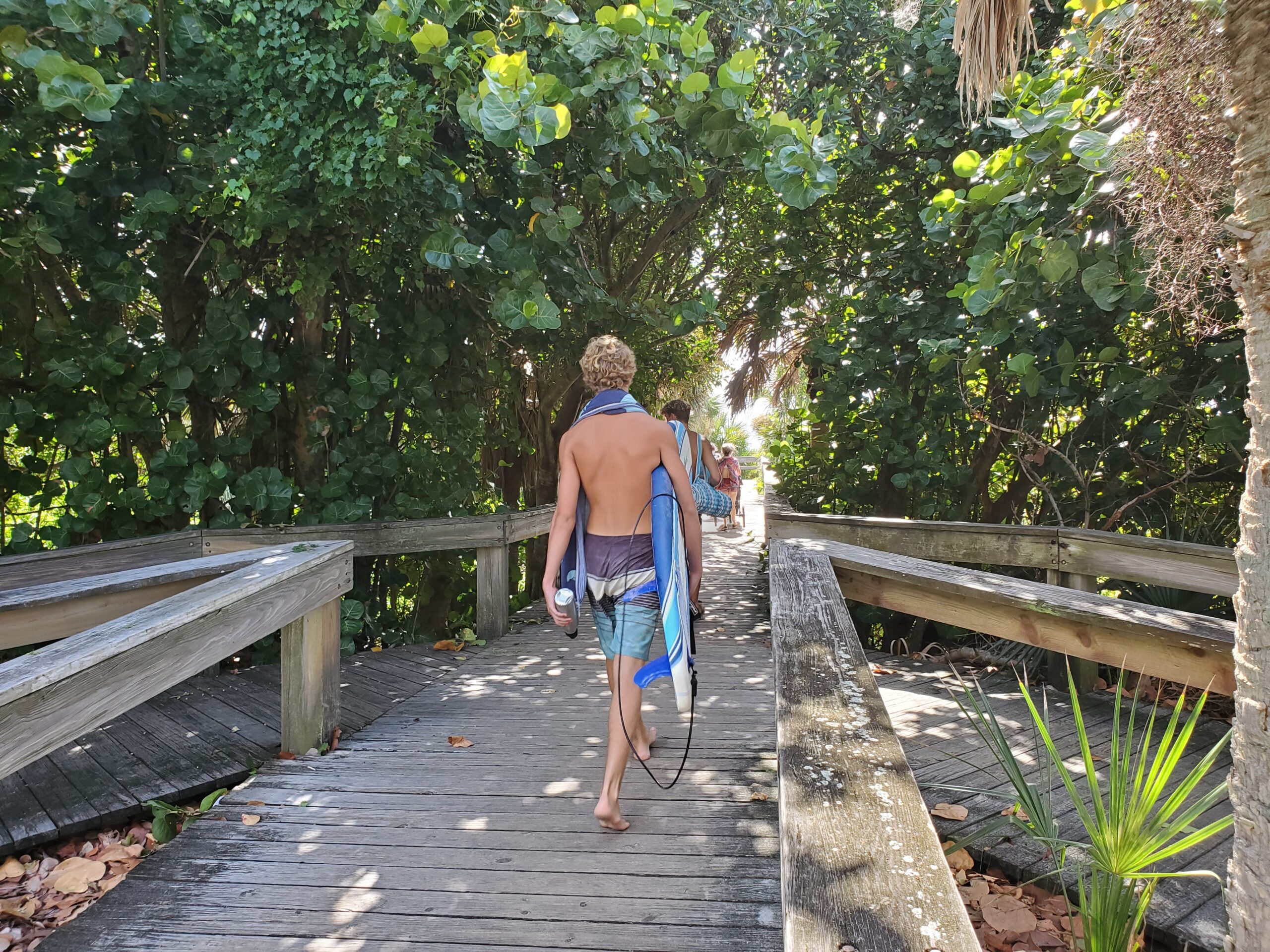 Surfers walking to Lori Wilson Park