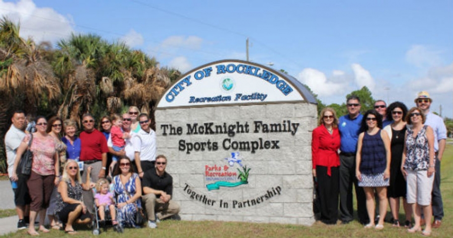 McKnight Family Sports Complex Group Photo Near Outdoor Sign