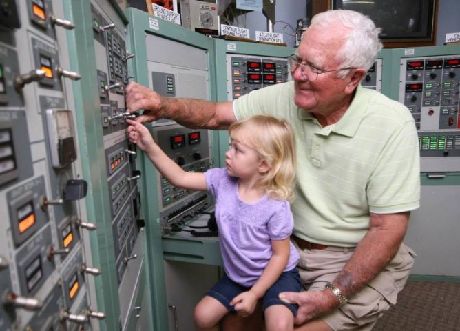 American Space Museum & Space Walk of Fame Grandfather and Child Play with Apollo Era Switches