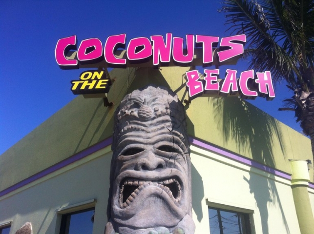 Coconuts on the Beach Outdoor Sign atop Tiki