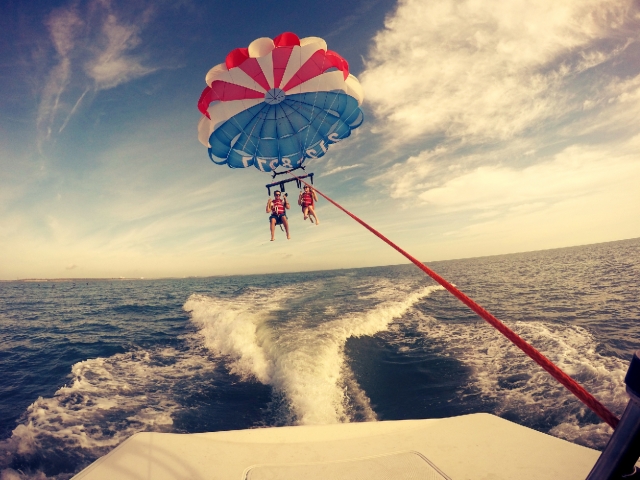 Cocoa Beach Parasail Couple Parasailing behind Boat