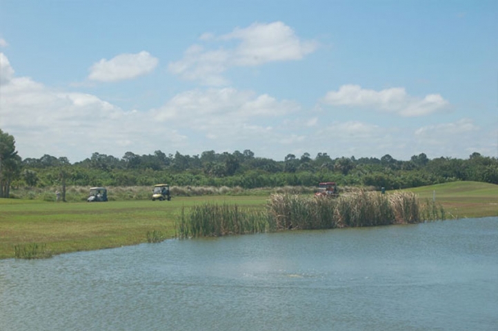 The Great Outdoors R.V. & Golf Resort Golf Carts on Greens next to Water