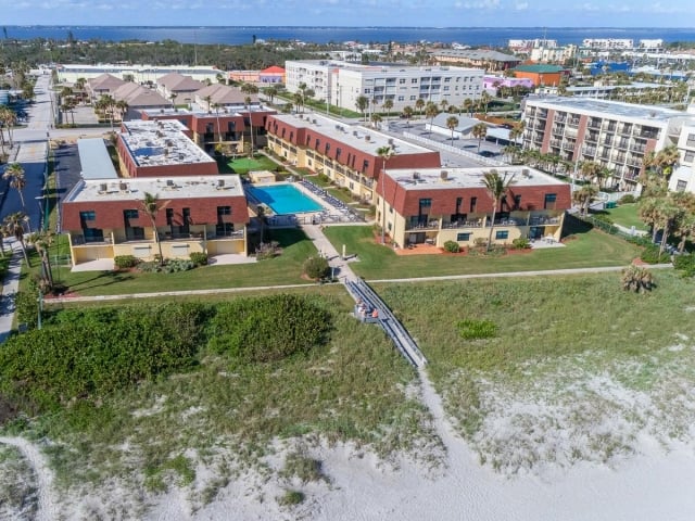 Cocoa Beach Club Condominium aerial view of the pool and property