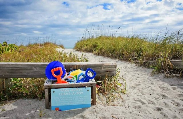 box of sand toys at beach entrance