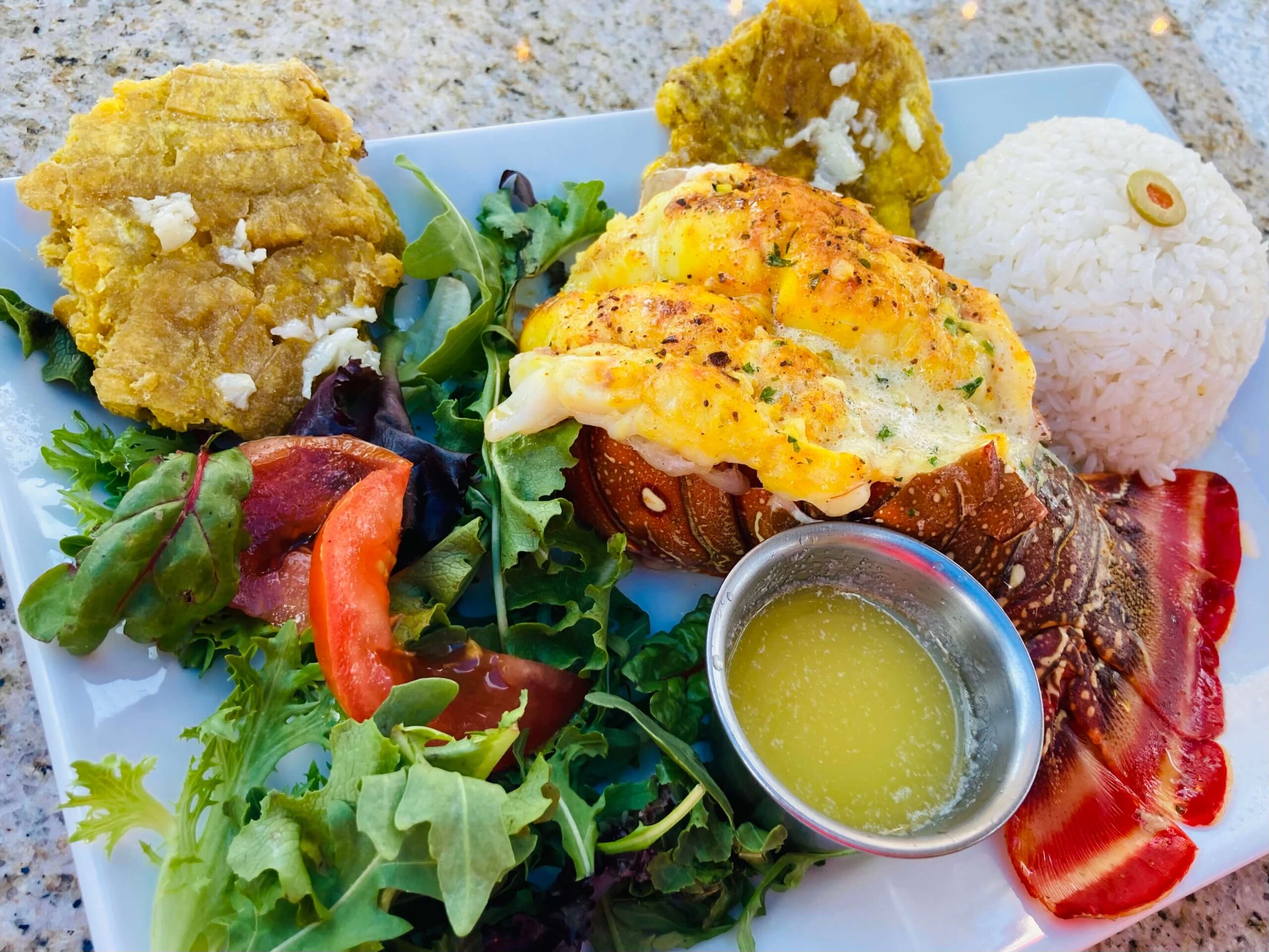 Lobster Tail, Rice, Fried Plantains and Salad from Latin Flavor Restaurant