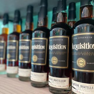 Bottles of Acquisition Bourbon Whiskey lined up