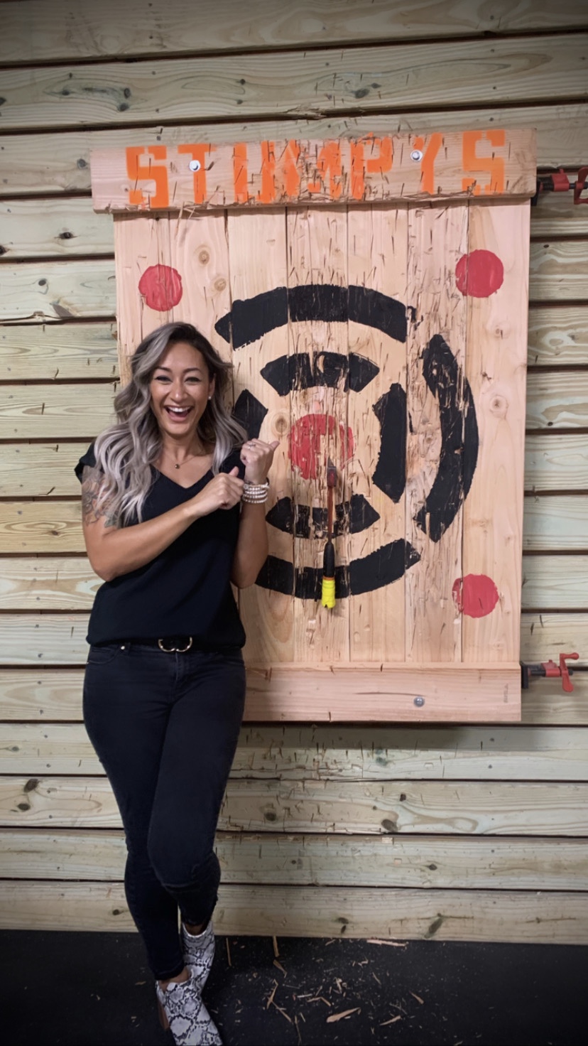 A woman poses in front of a target
