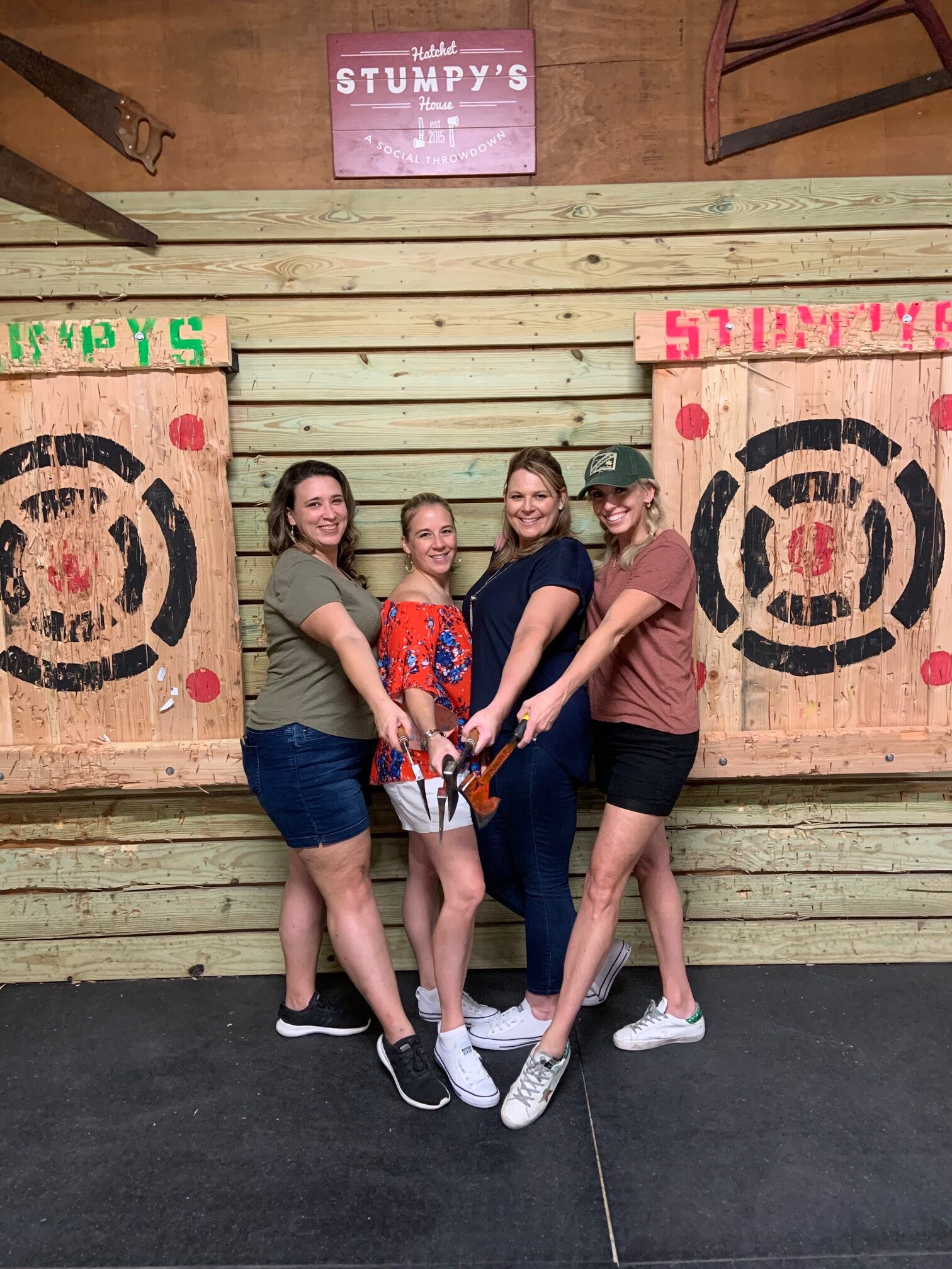 Ladies posing in front of a target