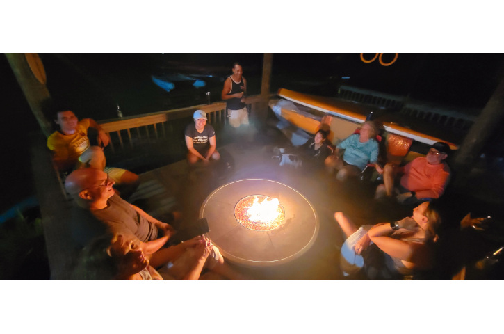 a group of people relaxing near firepit