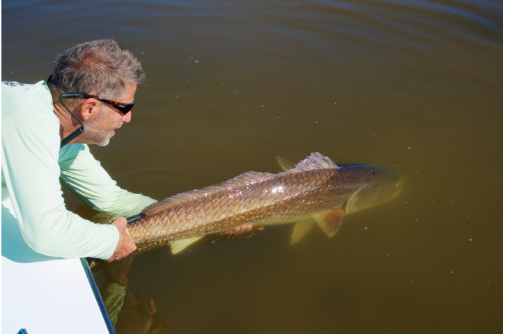 Captain Frank releasing a fish