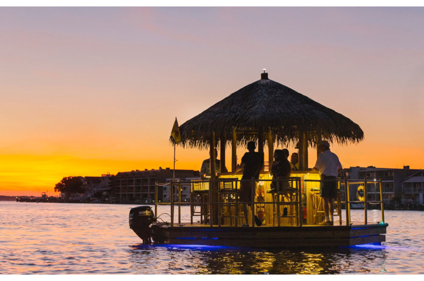 Guests enjoy a sunset tiki cruise