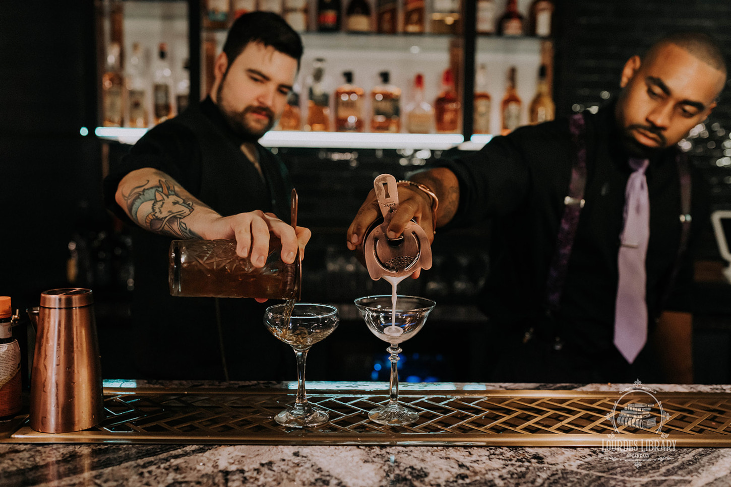 Lourdes Library bartenders pouring cocktails