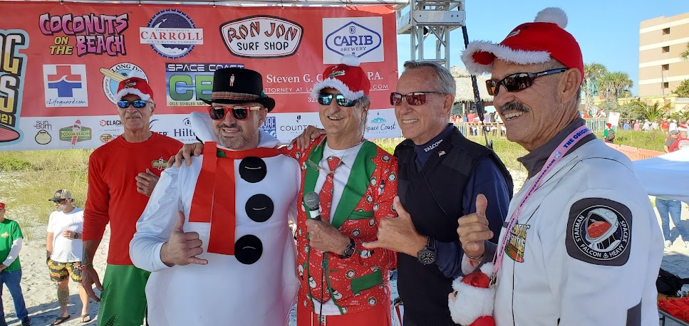 guys pose at surfing santas