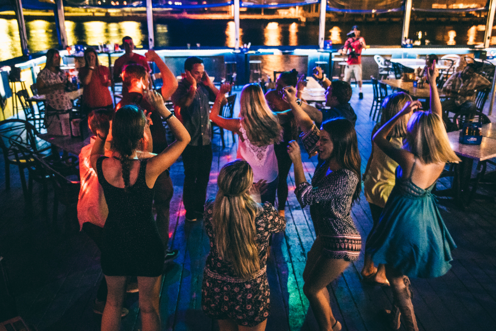 A group of millennials dancing and enjoying the nightlife at Fishlips Waterfront Bar & Grill in Port Canaveral