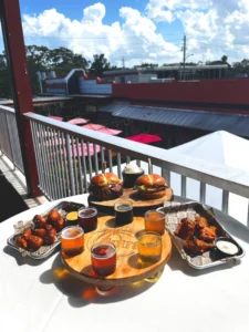 A flight of beers, pretzel bites, bone in chicken wings, a smash burger and a chicken sandwich from Intracoastal Brewing