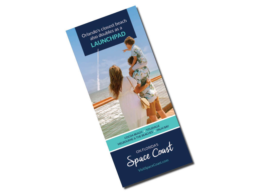 2025 Vacation Planner Cover with a family on the pier watching a rocket launch