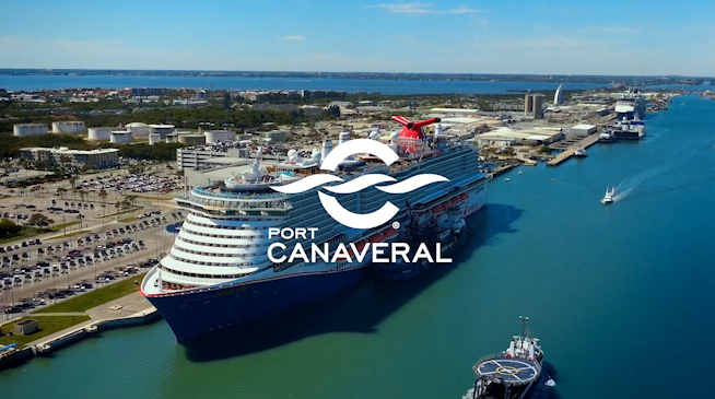 Cruise ship and drone ship passing with Port Canaveral Logo